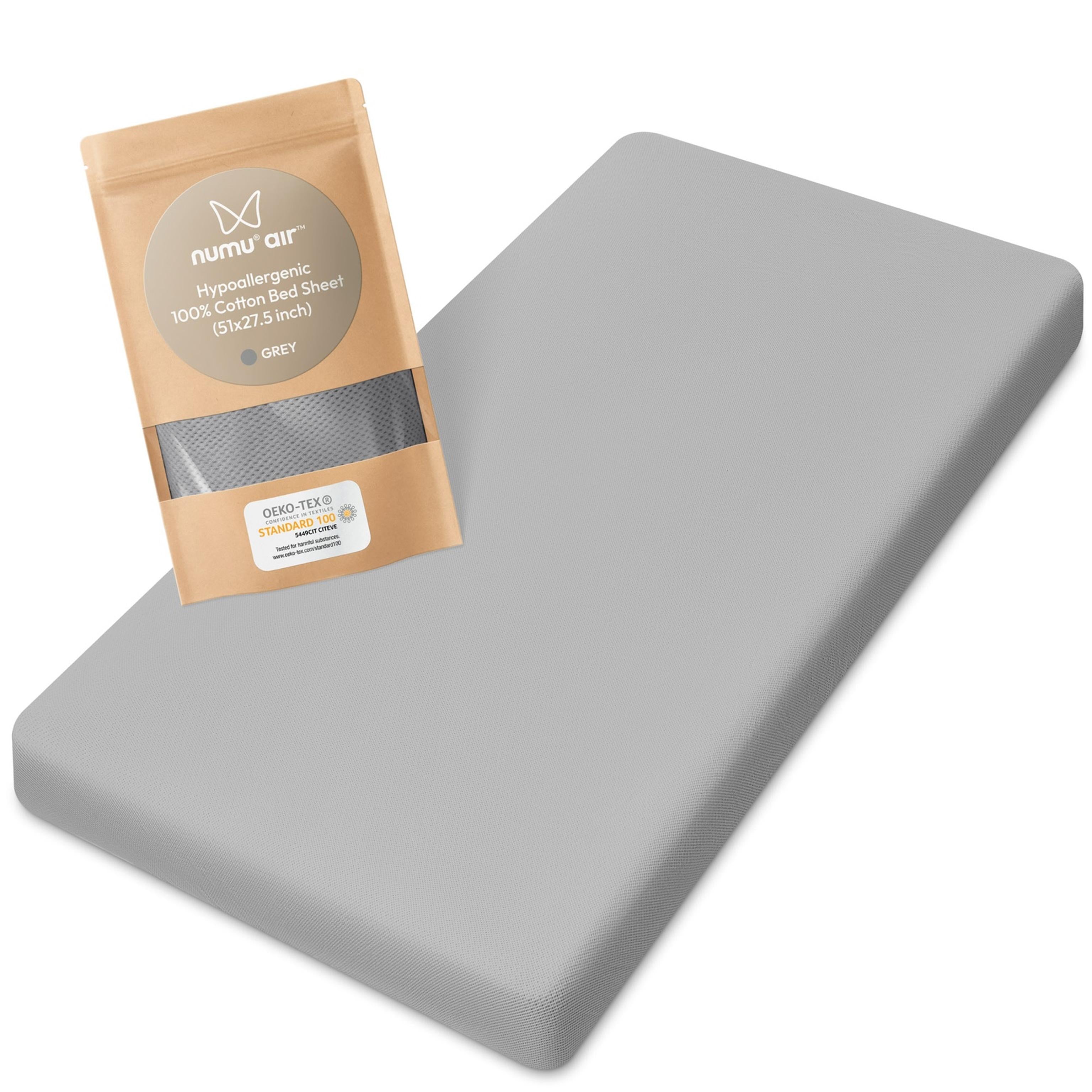 Gray crib sheet with numi air packaging on a white background