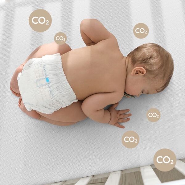 prone baby lying on numu air best mattress for newborn with badges sayin co2