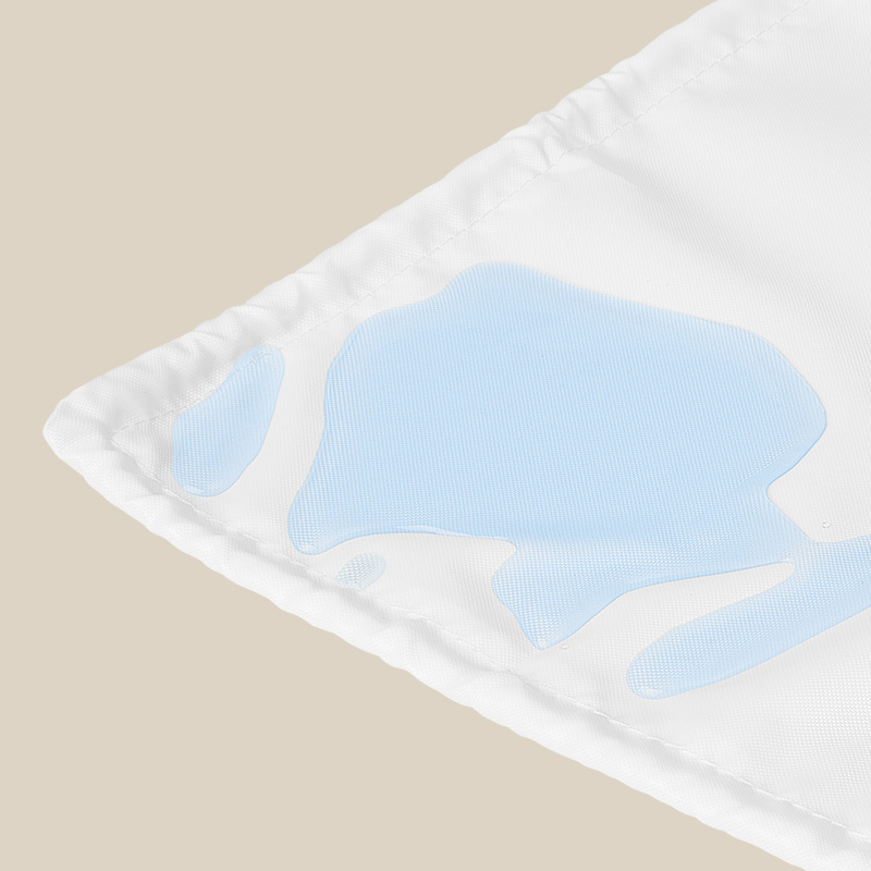 corner of crib base protector with water on it on beige background