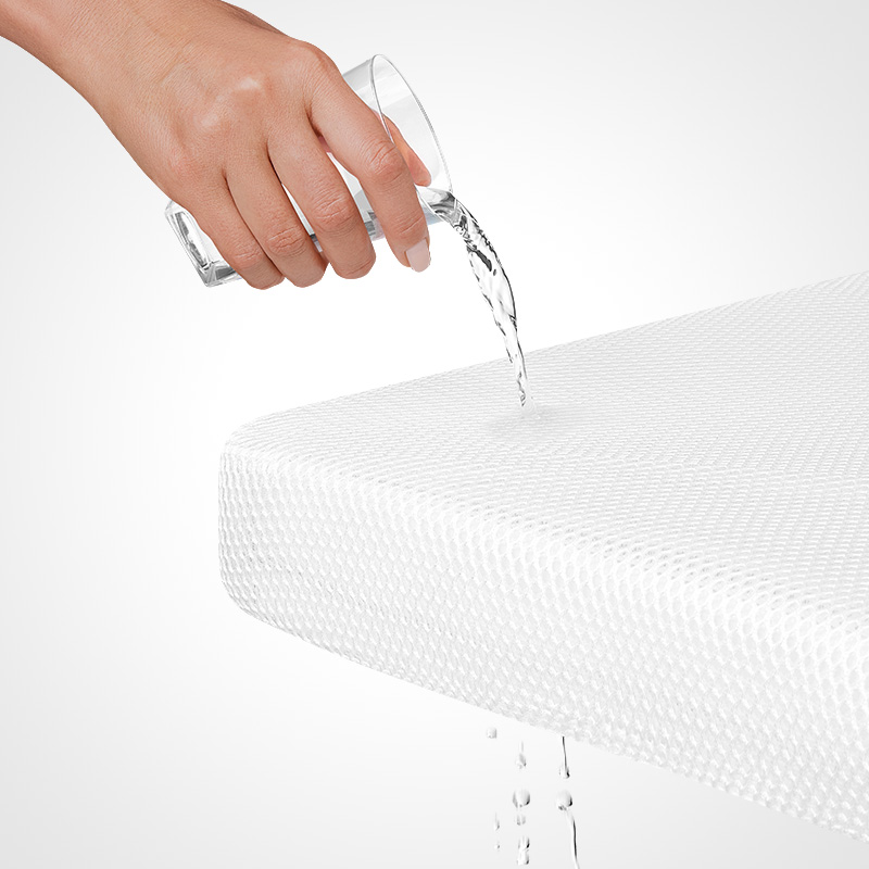 hand pouring water on numu air pediatrician recommended crib mattress showing full permeability